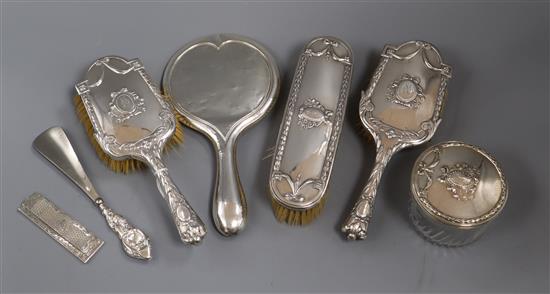 An Austro-Hungarian four piece white metal brush set and three other dressing items.
